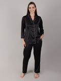 Woman wearing black satin pajama set on her honeymoon