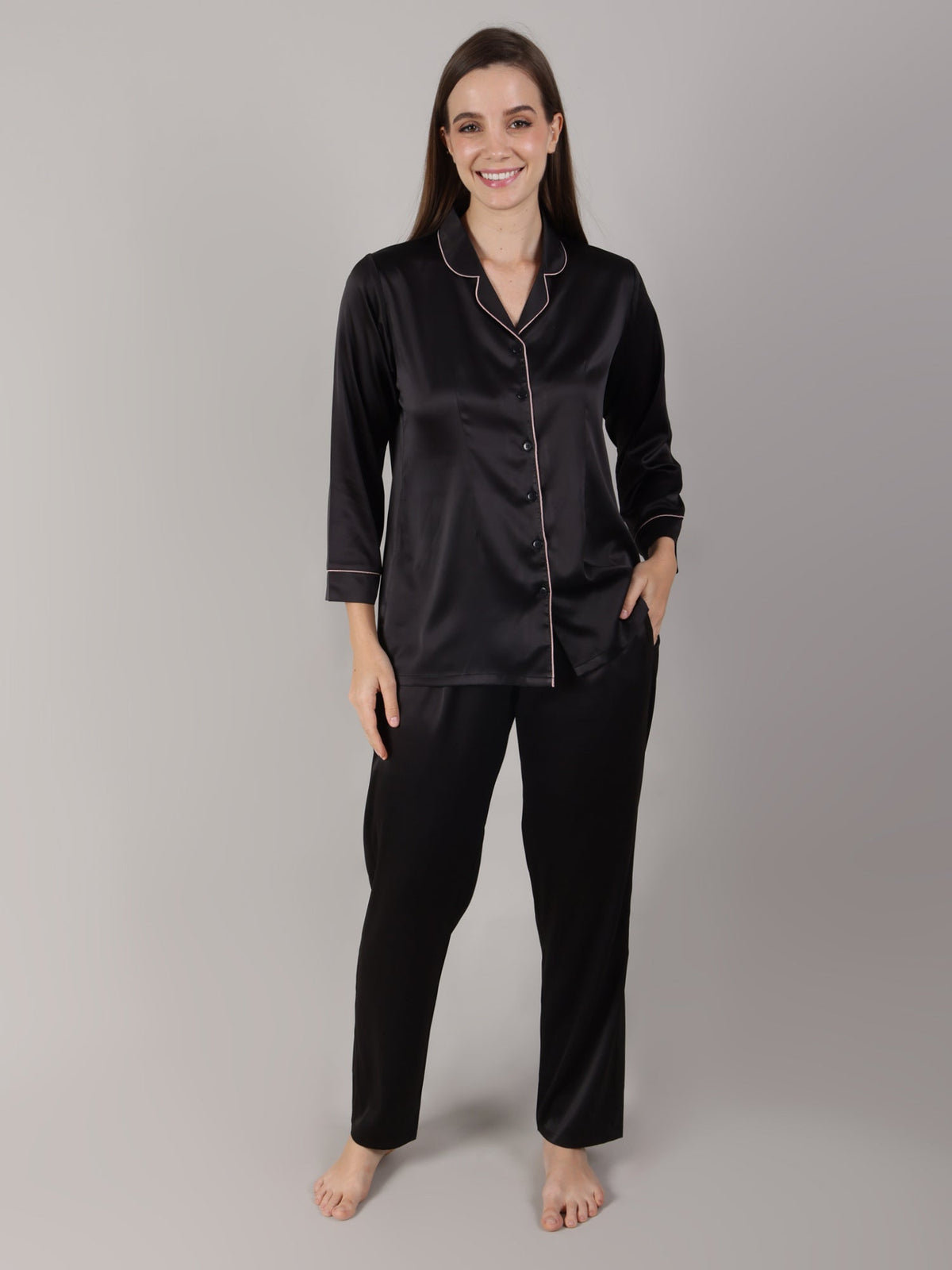 Woman wearing black satin pajama set on her honeymoon