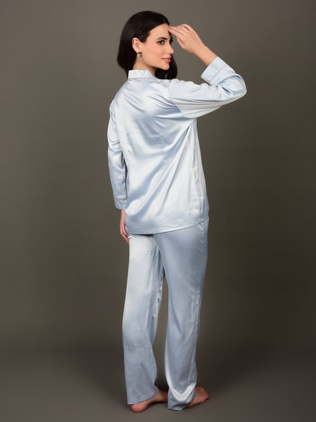 Woman wearing the ice blue night suit shows the back of the garment indicating darts which gives a silhouette to a woman's body. Idle for lounging, sleeping, vacations and even bridal nightsuits.