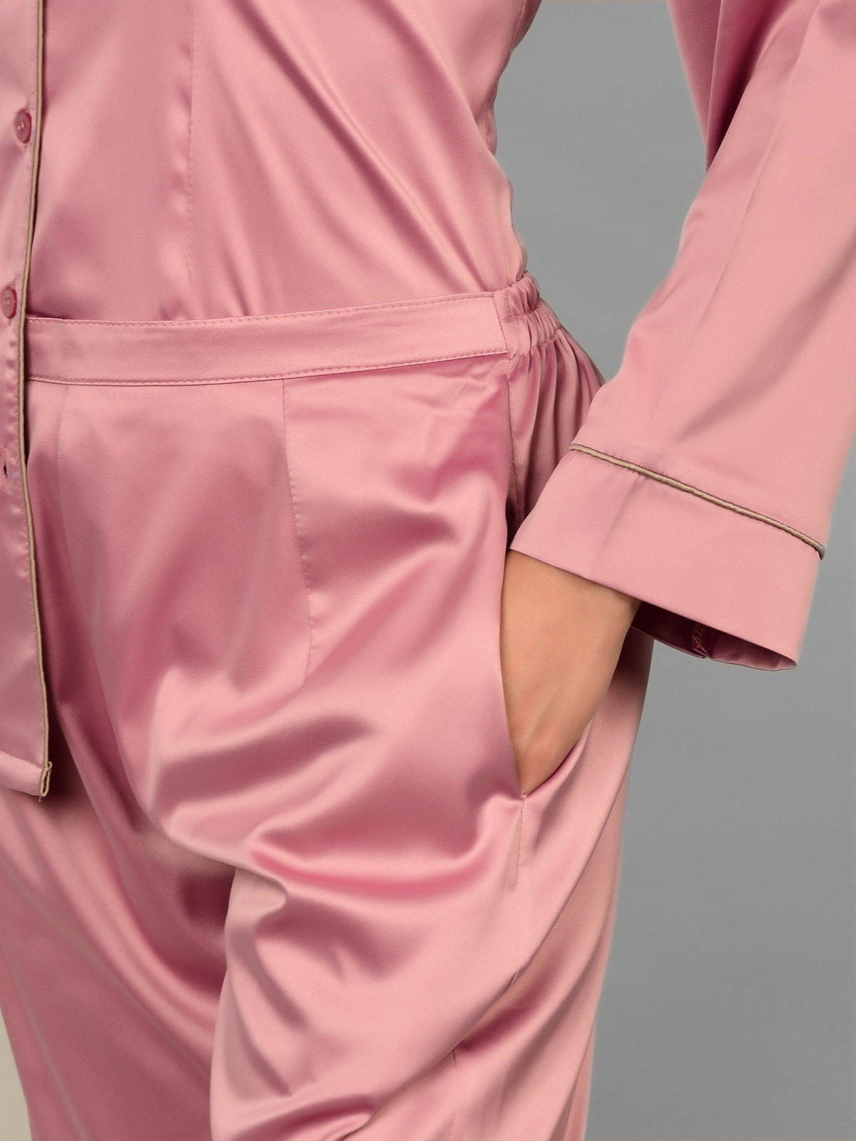 Woman wearing Rosete satin nightwear while lounging at home